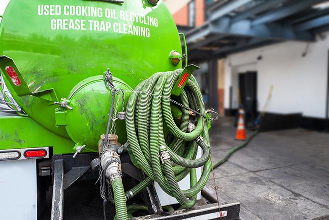 a technician pumping a grease trap in a commercial building in Palos Heights IL